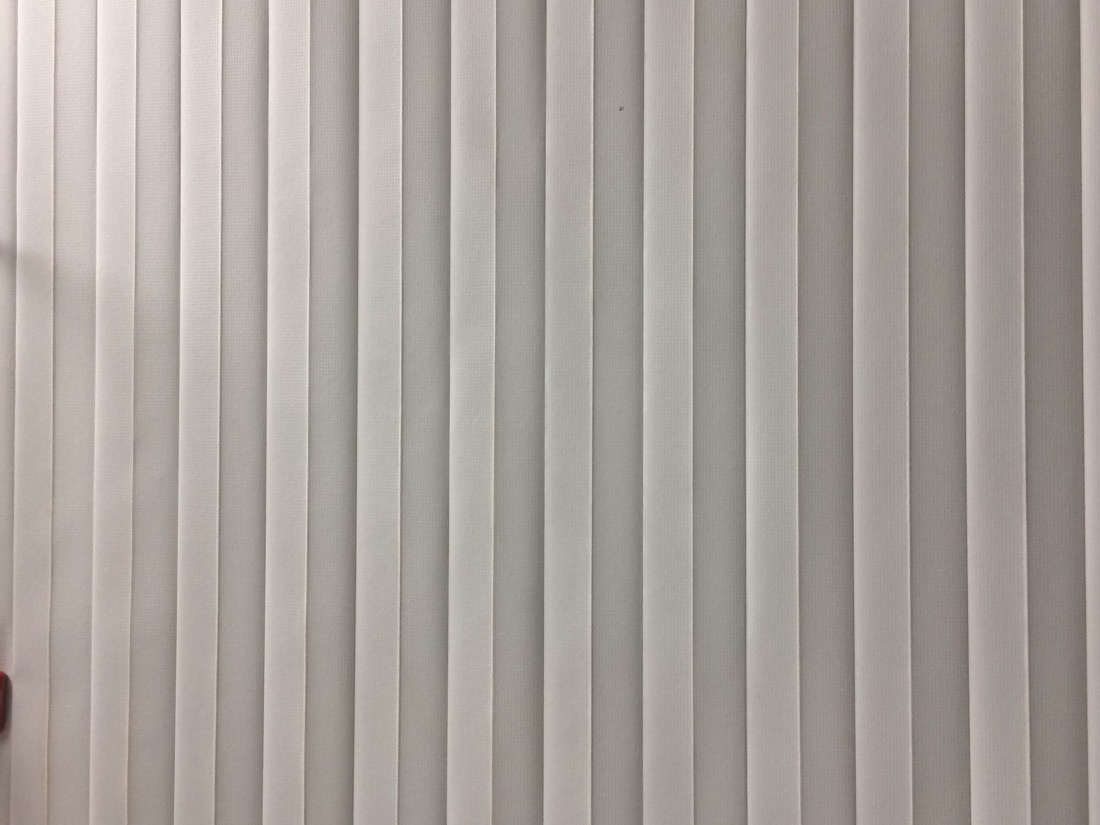 Bright clean white vertical blinds after Capital Blind cleaning