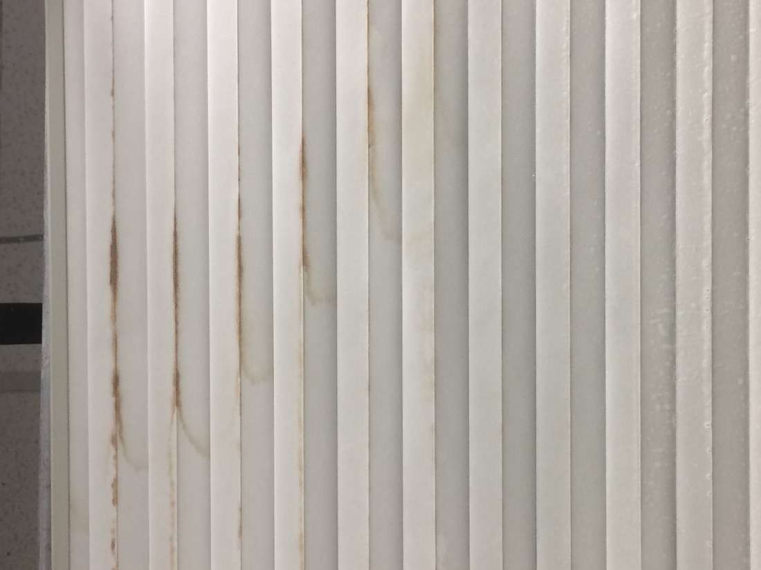 Stained, discoloured vertical blinds before cleaning